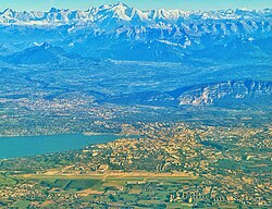 The Geneva area seen from above the Jura mountain chain, with the International airport in the foreground, and the Mont Blanc mountain range in the background