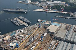 USS Kitty Hawk docking at the U.S. Navy base in Yokosuka, Japan