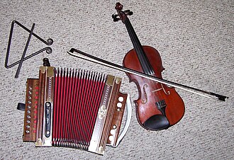 Traditional Cajun instruments: tit-fer, Cajun accordion, and a fiddle.