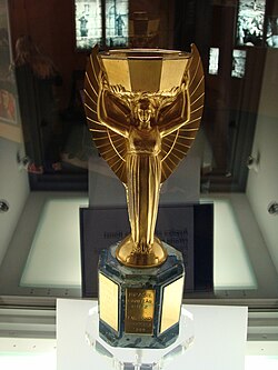 A replica of the Jules Rimet Trophy on display at the National Football Museum in England. The trophy was won by Italy during its back-to-back victories in 1934 FIFA World Cup and 1938 FIFA World Cup. The original was stolen from Brazil in 1983 and has never been recovered.