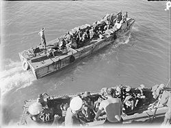 Indian troops embarking from the cruiser HMS Kenya in a landing craft assault (LCA 346) to take over from the Royal Marines, South of Ramree, Burma.