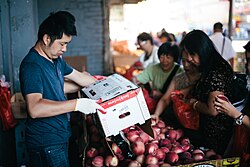 Street vendor selling fruit under the Flushing–Main Street LIRR station