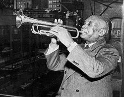 W. C. Handy in November 1949, playing trumpet in his music publishing office overlooking Times Square