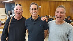 Seinfeld with members of Kibbutz Be'eri in the kibbutz dining room, December 19, 2023