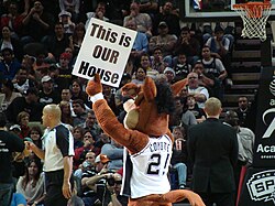 The Coyote showing a sign to the crowd during a time-out at a Spurs game