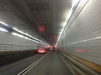 The Holland Tunnel crossing under the Hudson River, connecting Jersey City with Lower Manhattan.