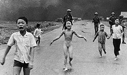 "The Terror of War" by Nick Ut, which won the 1973 Pulitzer Prize for Spot News Photography, showing a nine-year-old girl running down a road after being severely burned by napalm.