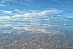 The Salar de Uyuni is the world's largest salt flat. Known for its vast white landscape, it becomes specially stunning during the rainy season.