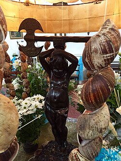 A statue depicting the orixá Xangô inside a Candomblé terreiro in São Paulo; he is distinguished by his double-headed axe, the oxê[46]