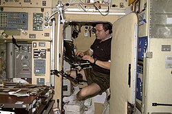 Cosmonaut Nikolai Budarin at work inside the Zvezda service module crew quarters
