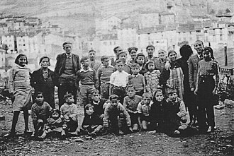 Refugees from the Spanish Civil War at the War Resisters' International children's refuge at Prats-de-Mollo in the French Pyrenees, some time between 1937 and 1939. The warden of the home, Professor José Brocca is standing third from left in the photograph.