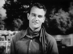 John Wayne as "Singin' Sandy" Saunders in Riders of Destiny