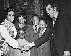 Coretta Scott King, NEC alumna and widow of Dr. Martin Luther King Jr., accompanied by her children, shakes hands with NEC President Gunther Schuller in Jordan Hall, May 1971.