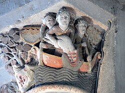 Jonah being swallowed by a great toothed sea-monster. Sculpted column capital from the nave of the abbey-church in Mozac, France, 12th century.