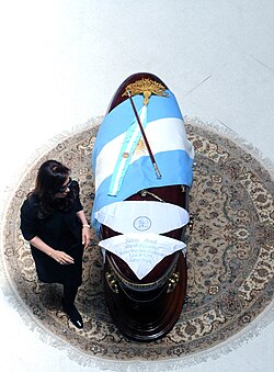 Fernández de Kirchner passing by her husband's flag-draped coffin, lying in state