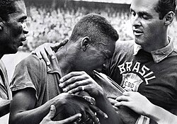 A 17-year-old Pelé cries on the shoulder of goalkeeper Gilmar after Brazil won the 1958 World Cup final.