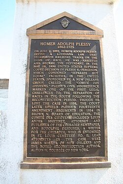 A bronze plaque on the side of Plessy's tomb in Saint Louis Cemetery No. 1, New Orleans, Louisiana, describes his historical significance.