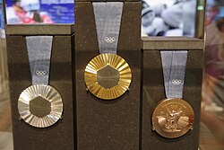 Medals from the Games, with a piece of the Eiffel Tower