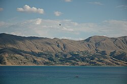 Color photograph of a lake with gorges leading into it