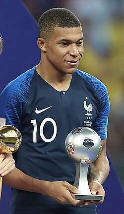 Mbappé holding his award for the 2018 FIFA World Cup Best Young Player
