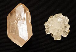 Crystallized sugar (rock candy) is made by adding a seed crystal to a supersaturated solution of table sugar and water. The multiple crystals on the right were grown from a sugar cube, while the left was grown from a single seed taken from the right. A red dye was added to the solution for the left crystal, but was insoluble with the solid sugar, and only traces remain while the rest precipitated out.