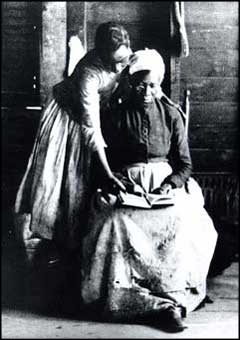 Former slave learning to read, 1870