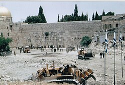 Upon Israel's occupation of the Old City of Jerusalem in the 1967 Arab-Israeli War, Israeli bulldozers cleared [he] what had been the Mughrabi Quarter, creating the Western Wall Plaza.[43] Scholars have discussed such moves as examples of Israel's Judaization of Jerusalem and Israeli settler colonialism.[43][44]