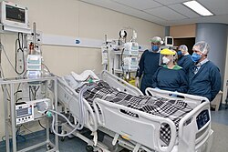 A critically ill patient receiving invasive ventilation in the intensive care unit of the Heart Institute, University of São Paulo in July 2020. Due to a shortage of mechanical ventilators, a bridge ventilator is being used to automatically actuate a bag valve mask.