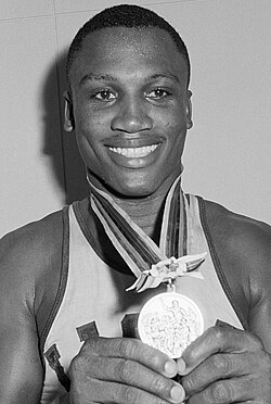 Frazier holding the 1964 Summer Olympics gold medal
