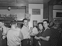 A sign posted above a bar that reads "No beer sold to Indians" (Native Americans). Birney, Montana, 1941.