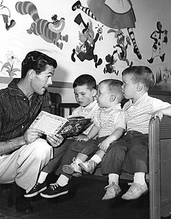 Carson reading a story to his three sons in 1955