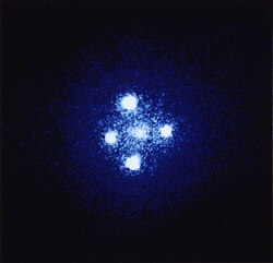 Einstein's Cross, four images of the same distant quasar around a foreground galaxy due to gravitational lensing – a single quasar is actually hidden behind a massive foreground object (a galaxy in this case)