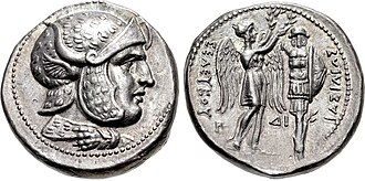 Coin of Seleucus I from the Susa mint. Obverse shows Seleucus wearing helmet covered with leopard skin and bull's horn and ear. Reverse shows Nike, holding in both hands a wreath that she places on trophy. Greek legend reads: BAΣIΛEΩΣ ΣEΛEYKOY, Basileōs Seleukou, "of king Seleucus".