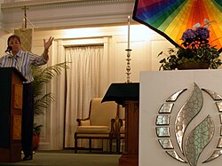 The Metropolitan Community Church logo in front of the altar at a regional conference of the denomination
