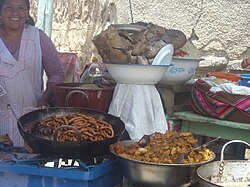 Peruvian cuisine—tarateño sausages and other foods sold by a street vendor in Tarata, Peru