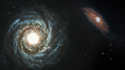 Two spiral galaxies, one of which has a very bright center