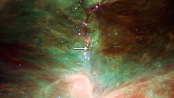 An arrow points to the embryonic star HOPS-68, where scientists believe forsterite crystals are raining down onto the central dust disk.
