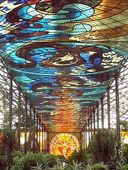 View of the interior of the Cosmovitral with the Sun Man in the background