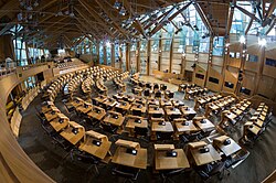 The debating chamber, where seating is arranged in a hemicycle rather than the adversarial layout of other Westminster style legislatures