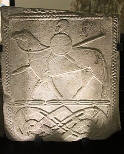 The Hornhausen rider stone is a 7th-century relief depicting a Frankish warrior on horseback with shield, longsword, and lance.