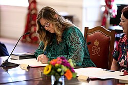 Luxton signing the oath during a ceremony at Government House, Wellington, on 1 February 2023 at which she was appointed a parliamentary under-secretary