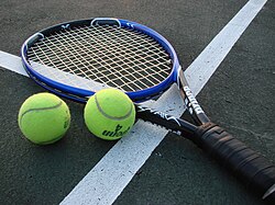 A tennis racket and balls