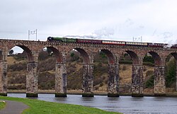 An older rail bridge in Berwick-upon-Tweed, retrofitted to include overhead catenary lines