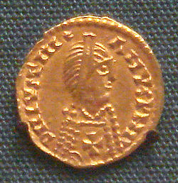 Spanish Visigothic gold Tremissis in the name of emperor Justinian I, 7th century. The Christian cross on the breast defines the Visigothic attribution. British Museum.