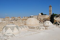 The roof of the baths, with the Ayyubid mosque and minaret in the background.