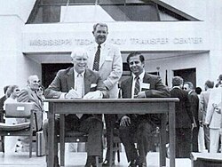 Allain (seated left) signing over the Mississippi Technology Transfer Center to the federal government in 1987