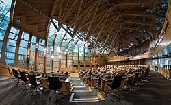 Seating in the debating chamber is arranged in a semicircle, with ministers sitting in the front section of the semicircle, directly opposite the presiding officer and parliamentary clerks.