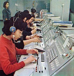 Operators at an international telephone exchange in 1967 in Japan at KDD, Japan's only international telephone company at the time. Replaced by International direct dialing which allows international calls to be placed without an operator.