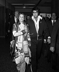 Elvis and Priscilla Presley arm in arm after their divorce was finalized in 1973