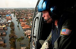 A U.S. Coast Guard aircrew searches for survivors in New Orleans during the aftermath of Hurricane Katrina.